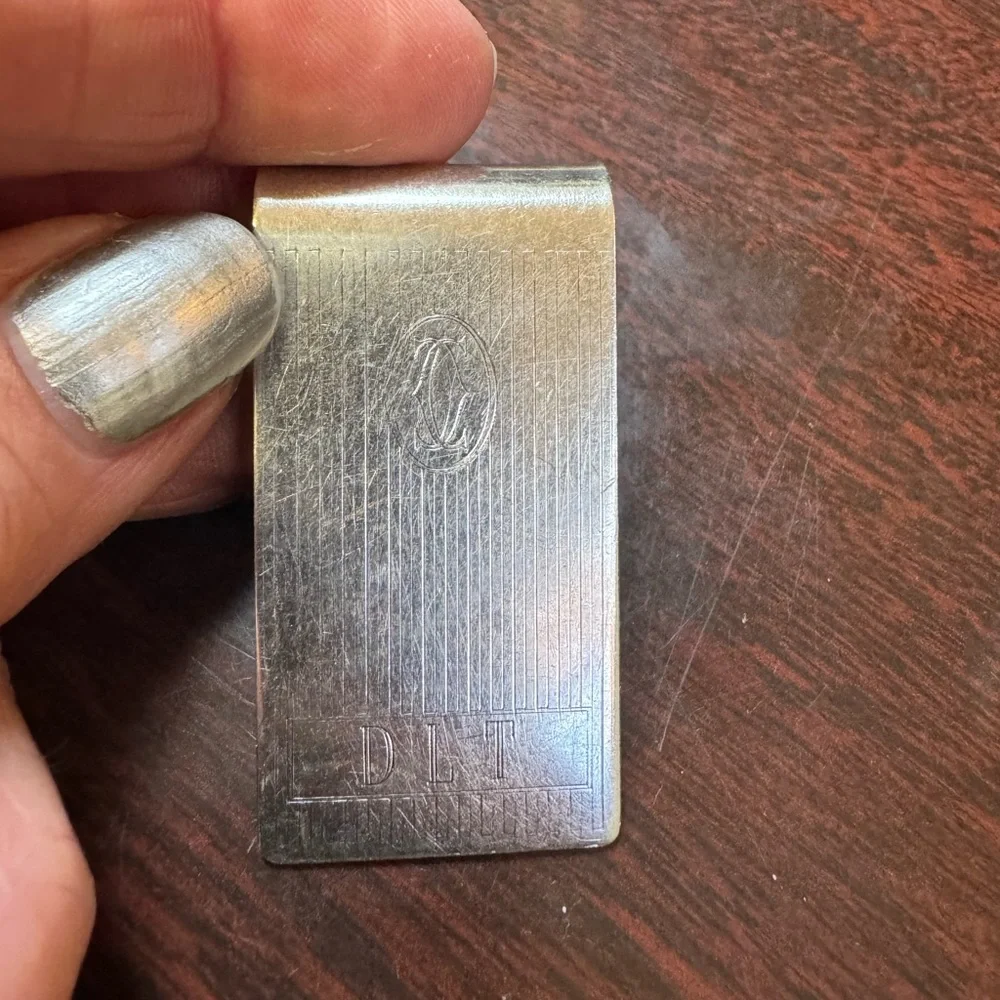 Cartier sterling silver money clip. Engraved with initials DLT.